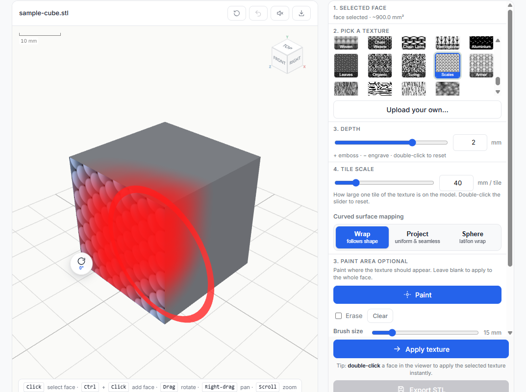 Scales texture preview on the cube face with a red painted brush zone showing where the texture will be applied
